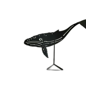 Black-painted steel sculpture of a humpback whale on a stand, featuring detailed cutouts and curves, capturing the whale's distinct silhouette.